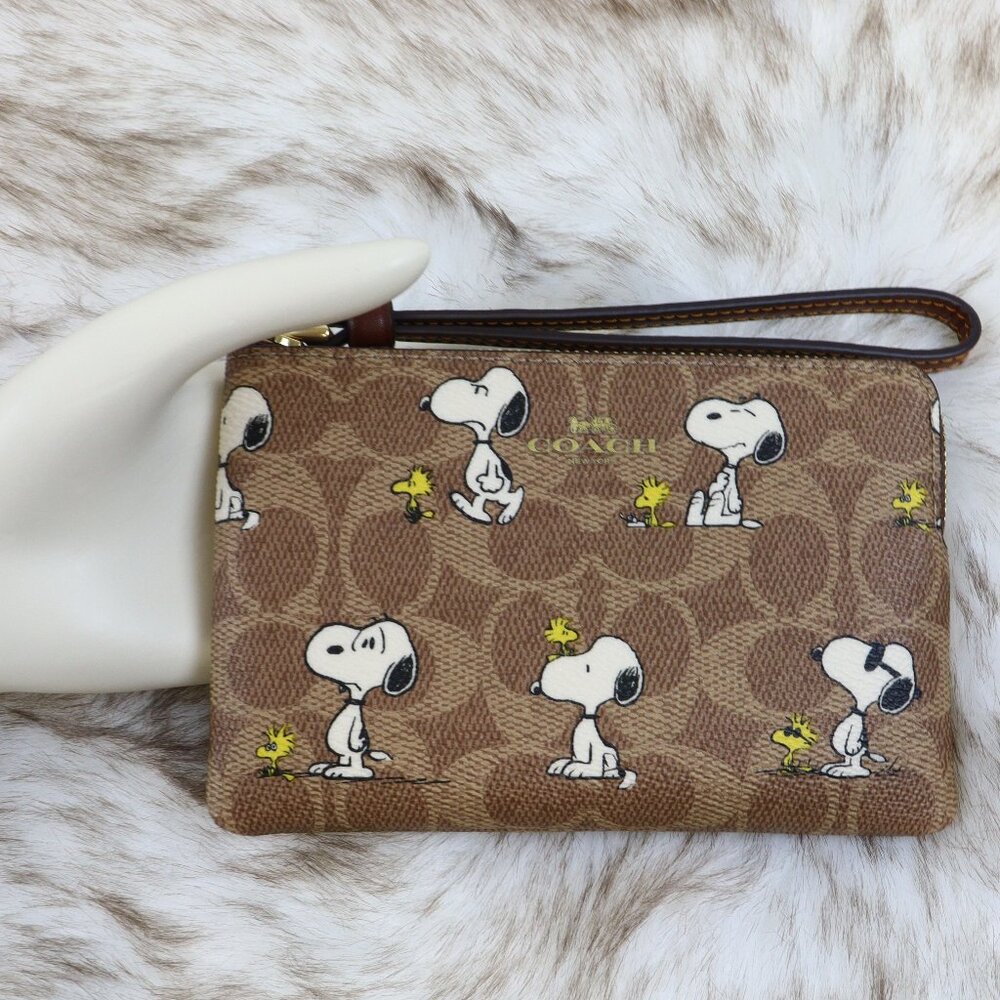 Coach x Peanuts Corner Zip Wristlet In Signature Canvas With Snoopy Print CBS82